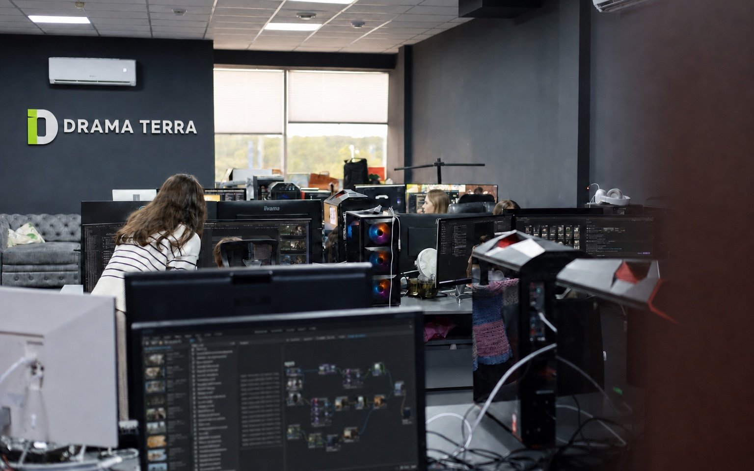 Drama Terra development room with writers mapping stories across multiple screens